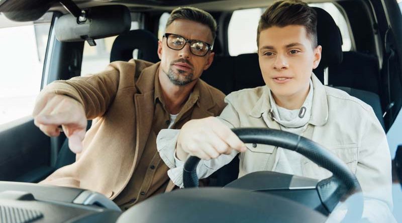 handsome-father-pointing-on-something-while-teachi-2021-08-30-19-15-53-utc